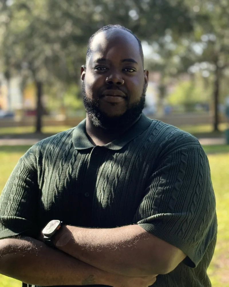 Jaylon Ballard, founder of the National Gridball League, standing outdoors with arms crossed